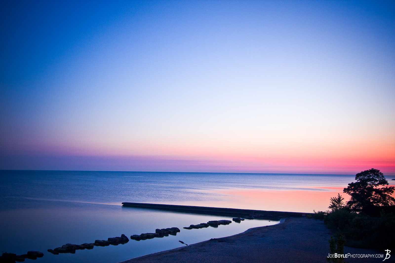  This image of the Lake Erie Coast was taken in the early morning hours at Rocky River Park located near Cleveland, Ohio. It happened that one particular night I couldn't sleep very well so I called it quits & started my day earlier than I planned. The thought then came into my mind to go down to the park and see if I can get some cool shots. What else is there to do for a photographer who is up before sunrise? It was a perfect morning to try such an experiment! 