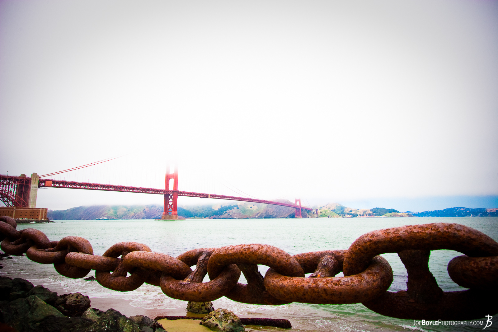  A photo of the San Francisco landmark taken from sea level. There is a pretty hefty chain keeping people from going out into the bay. I did however witness a few people swimming from the shore, to the middle of the bridge and back while I was photographing the bridge! That was quite a sight! 
