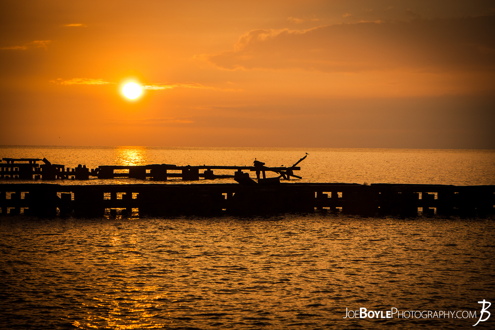  A beautiful sunset off the coast of Lake Erie with a pier in the foreground. This image was captured in Cleveland Ohio, specifically near Edgewater Park.  