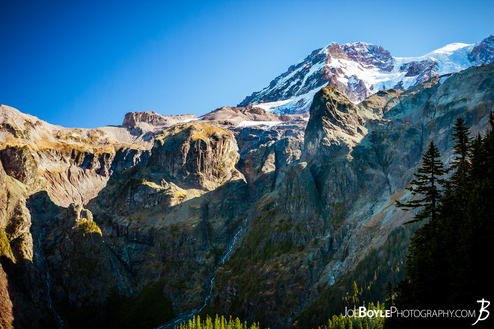  I captured this photo on our descent from the Klapatche campground on to the Golden Lakes Camp Site. What you see here is Tokaloo Spire & Tokaloo Rock in the foreground with Rainier in the background. 