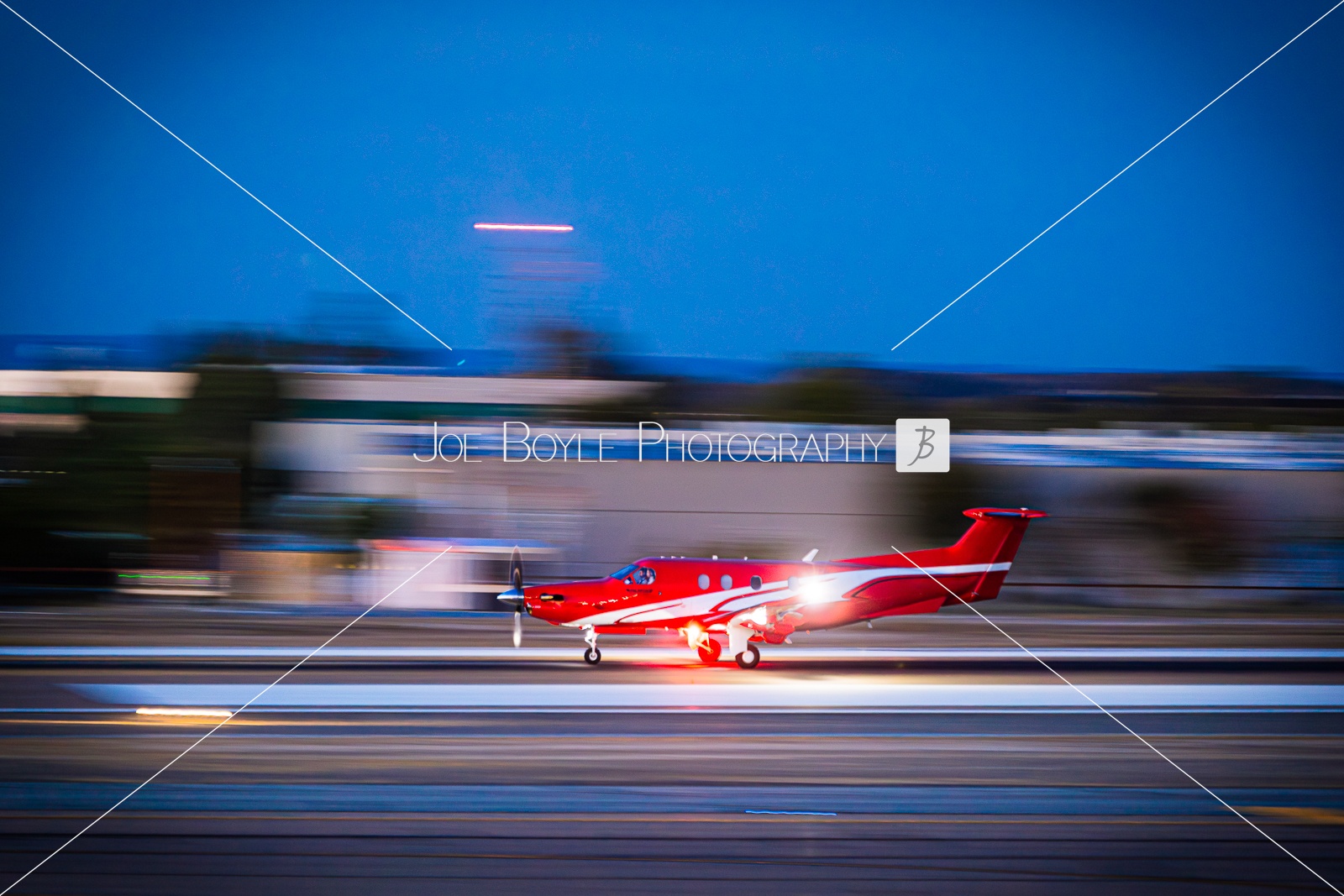  Airplane taking off at Night. It's a panning shot of a Pilatus aircraft 