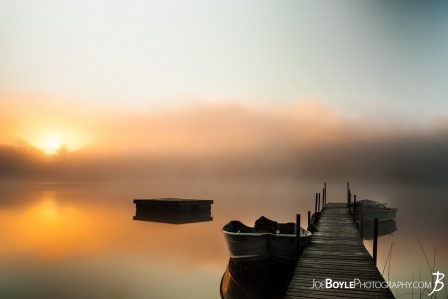 calm-misty-lake-with-pier-and-boats-ii